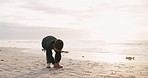 Boy, drawing and heart in sand, beach and playful game for art, vacation and nature in sunshine. Male child, love icon and writing in dirt by ocean, holiday and outdoor with sunset, freedom or summer