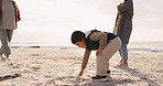 Boy, family and drawing in sand, beach and playful game for art, vacation and nature in sunshine. Male child, mother and writing in dirt by ocean, holiday and outdoor with women, freedom and summer