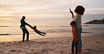 Beach, sunset and family taking a picture while on vacation, adventure or holiday together. Playful, bonding and young parents playing and having fun with their boy children by ocean on weekend trip.