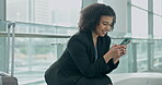 Phone, networking and a business woman in an airport for an international trip or communication. Smile, travel and a happy female employee waiting for her flight in an arrival or departure lounge