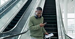 Luggage, phone and a happy man on escalator for travel with communication and connection for chat. African male person with a ticket, suitcase and smartphone excited to check flight or hotel booking