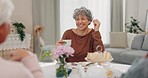 Tea, funny and senior woman with friends in home living room, bonding and talking at table. Happy people, elderly person and laughing at comedy, story and smile for conversation, gossip and coffee