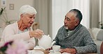 Elderly woman, man and pouring tea at book club, bible study and talking at brunch in nursing home. Senior couple, relax and drink with bible, reading and conversation for knowledge in retirement