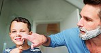 Playful, shaving and a father teaching his son about grooming or hygiene in the bathroom of their home together. Face, family and kids with a boy child learning how to shave with his single parent