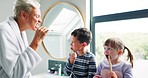 Mother, children and bathroom with teaching, brushing teeth and care for mouth, gums and hygiene in home. Mom, young kids and learning with cleaning, health and wellness in morning at family house