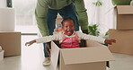 Child, father and pushing box in new house for playing games or race with speed for bond, love or happiness. Dad, excited or African kid in car with support or helping hand on floor in family home