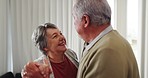 Senior couple, dancing and home with marriage, retirement and love with music. Elderly people smile and happy from playful romance and care in a house lounge together in a living room with joy