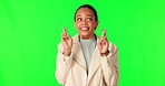Green screen, woman and fingers crossed in studio for good luck, hope and wish on mockup background. Emoji, hands and female person waiting for news, outcome or lottery, bonus or competition results 