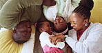 Floor, above and black family playing in a living room or lounge happy, love and bonding together at home. Funny, mother and African father enjoy quality time with kids for care, relax and happiness