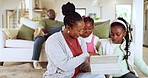 Mother playing a game on a tablet with kids in the living room for bonding together at home. Happy, love and African girl children browsing on social media or internet with mom on digital technology.