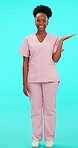 Smile, funny and palm with a nurse black woman on blue background in studio for healthcare. Portrait, medical and product in the hand of a happy young female medicine professional laughing in scrubs