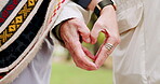 Senior, love and hands with heart sign for care, hope and trust in a park for a romantic outdoor date together. Support, symbol and gesture or emoji by elderly people in a relationship in nature