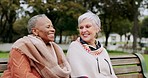 Senior women on bench in park with smile, friends and outdoor adventure in garden for quality time. Happiness, friendship and retirement, old people bonding together in nature for freedom and fun.