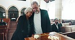 Funeral, coffin and senior couple hug for goodbye, mourning and grief in memorial service. Depression, sad family and man embrace woman by casket in church for greeting, loss and burial for death