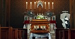 Coffin, church and funeral service in closeup, memorial and event to celebrate life, worship and faith. Casket, burial and memory with death, mourning and compassion for farewell, sermon and religion