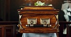 Casket, church and funeral with service in closeup, zoom or event to celebrate life, worship or faith. Wood coffin, burial and memory in death, mourning or compassion for farewell, temple or religion