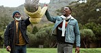 Family, swinging and park fun with grandfather, dad and child happy outdoor with walking. Care, African senior man and father with young kid and smile playing in a field on holiday together in nature