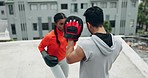 Boxing, woman and rooftop with personal trainer, fitness and workout with cardio. Exercise, sport and kickboxing for fight outdoor with a man coach and female athlete together for strength training