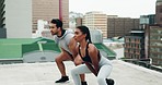 Exercise, athlete and rooftop with kettle bell, squats and workout in city outdoor. Personal trainer, strength training and motivation of a woman and man on a roof with sports and weight for fitness