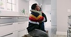 Education, backpack and a father with his son getting ready for school in the kitchen of their home together. Family, children and a man hugging his kid for goodbye in the house before leaving