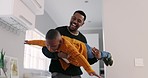 Airplane, love and father with boy child in a living room playing, happy and bond in their home together. Flying, fun and family time with parent and kid in a house with games, smile and playful