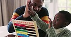 Black family, abacus and father high five child for education, learning and math lesson at home. School, academic and happy dad teaching boy at table for development, homework and educational toy