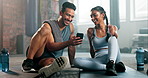 Couple of friends, phone and fitness for training support, funny meme or social media check and reading online at gym. Happy man and woman or personal trainer relax on floor for exercise conversation