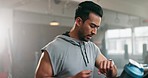 Asian man, fitness and running on treadmill for exercise, workout or cardio training and checking watch at gym. Active, runner or sports male person and athlete looking at wristwatch for healthy body