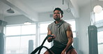 Fitness, rope exercise and a man at gym for body builder training and wellness. Asian athlete person with focus, heavy or battle ropes for power, strong muscle and workout or challenge for health