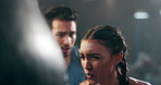 Motivation, boxer or personal trainer at gym with woman in exercise or workout for fitness or fighting. Punching bag, support or healthy sports athlete training with coach for strong power or boxing