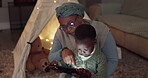 Night, tablet and family with a child at home watching movie or video for e learning. African woman or grandmother and kid together in lounge with tech for education, streaming and e book or story