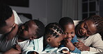 Night, talking and family on a bed together at home for bonding, comfort and care. African woman, man or parents and happy kids for story time, fun conversation or playing to relax at a house