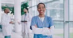 Black woman, arms crossed and nurse, face and health with smile, confidence and help at hospital. African female person, medical expert and service with healthcare, portrait and happy professional