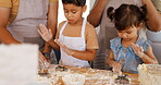 Family, learning and parents baking with kids in a kitchen table together to prepare cookies or biscuits recipe at home. Development, mother and father teaching or helping children cooking in a house