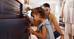 Family, children and open drawer in home, play and curious, smile and happy together. Kids, father and mother on cupboard, learning and education, bonding or having fun, care or teaching in house