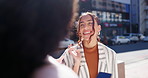 Happy woman, friends and talking by city street for communication, networking or conversation. Women having a friendly discussion or chatting together on sidewalk with shopping bag in an urban town