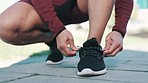 Fitness, exercise and hands tie shoes in nature for running, marathon training and sports outdoors. Start, performance and closeup of person tying lace for wellness, cardio workout and healthy body