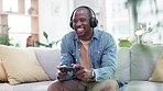 Man, headphones and video game with controller, couch and excited for virtual user experience, streaming or esports. African guy, online gaming and thinking with press, click and strategy for contest