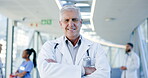 Doctor pride, face and a man with arms crossed for healthcare, emergency service or nursing. Happy, hospital and portrait of a mature surgeon or clinic worker with confidence in medical career