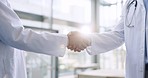 Hands, teamwork or doctors shaking hands for success, good job or promotion goal in a hospital meeting. Closeup, congratulations or proud healthcare worker with handshake for medical collaboration