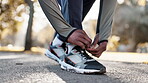 Hands, lace sneakers and start run outdoor, fitness and cardio with person ready for race or marathon in park. Shoes, runner in nature and exercise with sports, training and prepare for workout