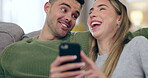 Laughing, talking and a couple with a phone on home sofa for connection, communication and meme. Young man and woman together on couch with a smartphone for internet, funny vide or social media chat