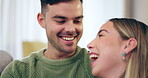 Couple, love and laughing on home sofa with happiness, care and support in healthy marriage. A happy man and woman together in a lounge talking about a funny joke, bonding time or relax on couch