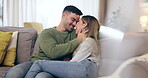 Couple, love and nose touch on home sofa with happiness, care and support in healthy marriage. A happy man and woman together in a lounge with affection while laughing, bonding time or relax on couch