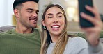 Kiss, happy and a couple for a selfie on home sofa for connection, social media and memory. Young man and woman together on couch for a profile picture for internet, network and healthy marriage