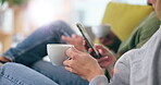 Search, phone and coffee with hands of couple on sofa for peace, social media and networking. Relax, tea and technology with closeup of man and woman in living room of home for communication app