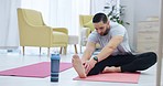 Fitness, stretching and man doing yoga in the living room for body, mind and spiritual wellness. Calm, meditation and young male person doing a pilates exercise for zen in the lounge at his apartment