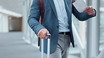 Hand, suitcase and a business man walking in the airport with a boarding pass for an international flight. Corporate, travel and time with a professional employee on a bridge in a departure terminal