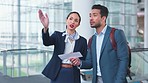 Woman, man and point for direction at airport concierge, help and question with check in lobby. Confused entrepreneur, airline service employee and show documents for identity, travel and information