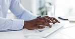 Hands, keyboard and a business man typing on a computer while working at his desk in a professional office. Website, internet and email with a corporate employee using a desktop pc in the workplace